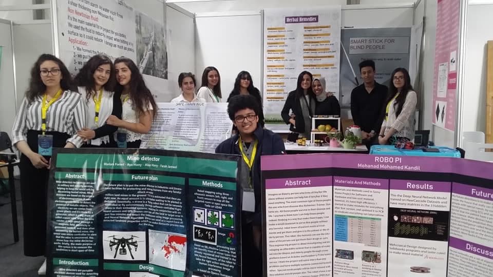 Science-fair exhibitors with their project posters, including my ROBO PI poster